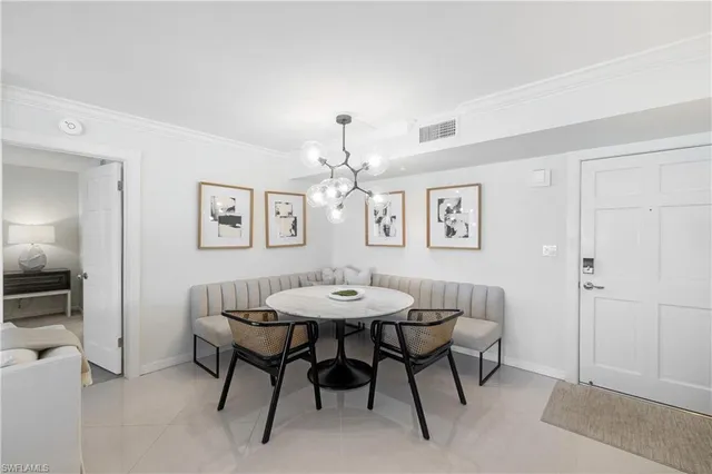 a dining room with furniture and a chandelier