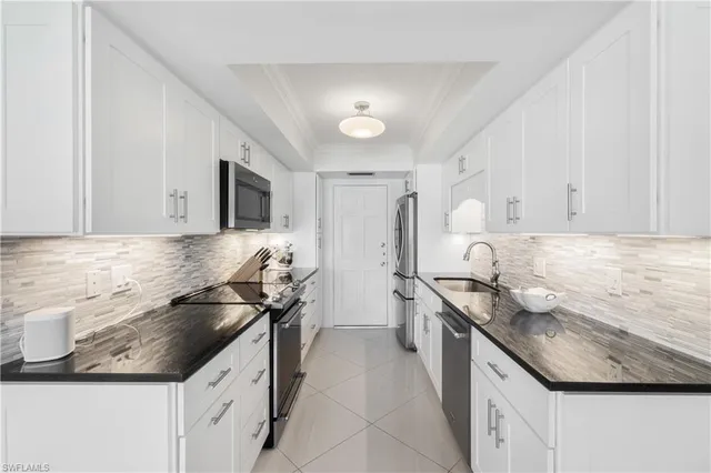 a kitchen that has a sink and a stove