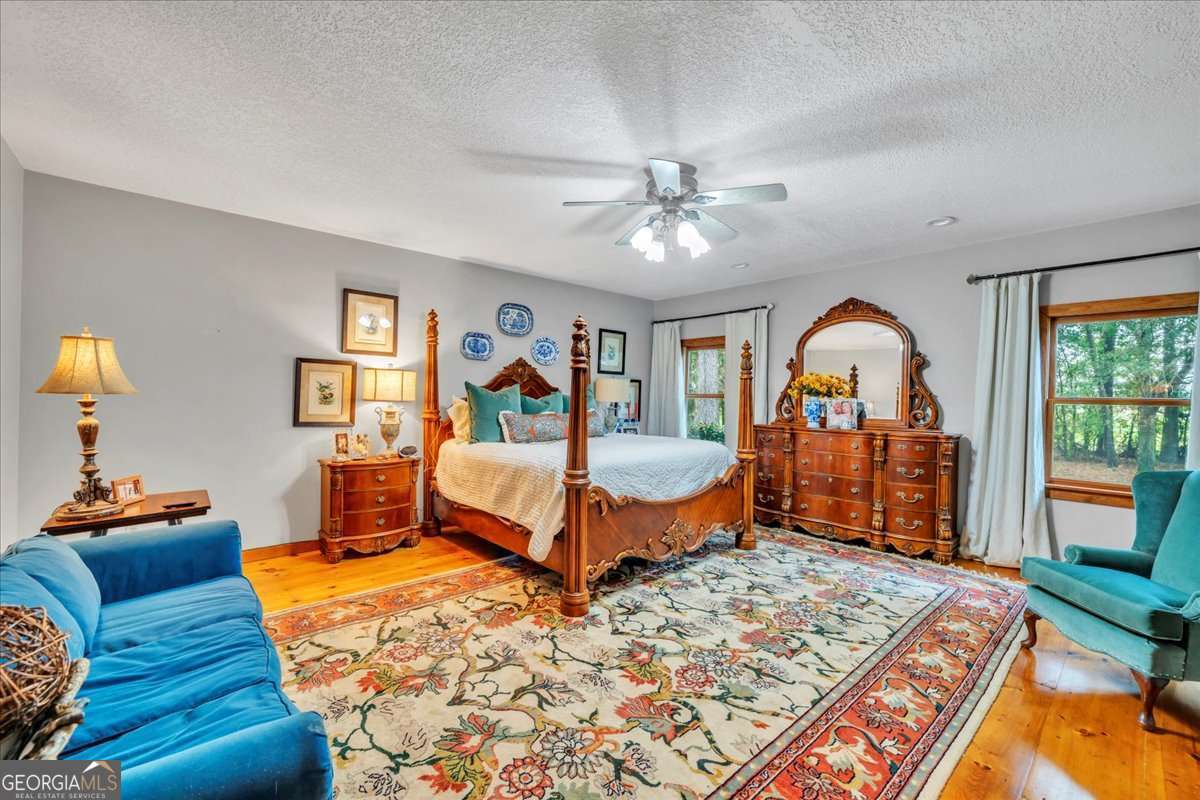 568 Hopewell Church Road Rhine, GA 31077 - Photo 18 of 79 a bedroom with a large bed and a chandelier