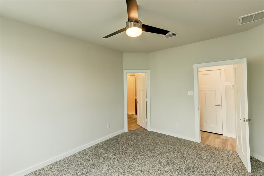 760 Double Mountain Road College Station, TX 77845 - Photo 11 of 26 an empty room with a ceiling fan and a window