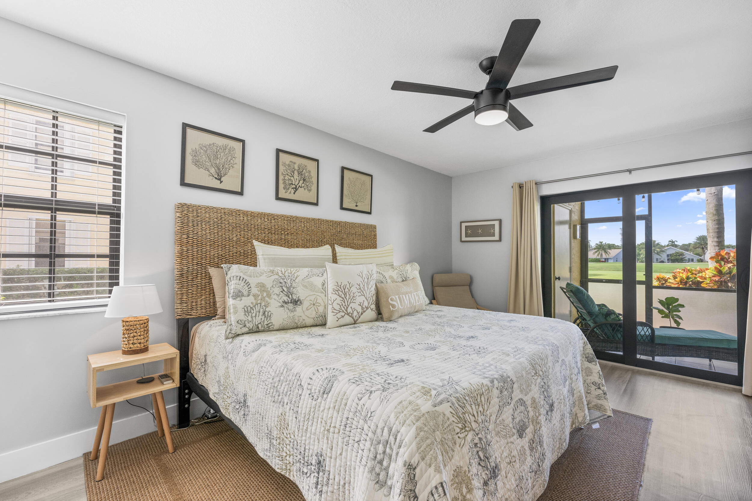 17867 Thelma Avenue, Unit A Jupiter, FL 33458 - Photo 11 of 35 a bed room with a bed and a large window