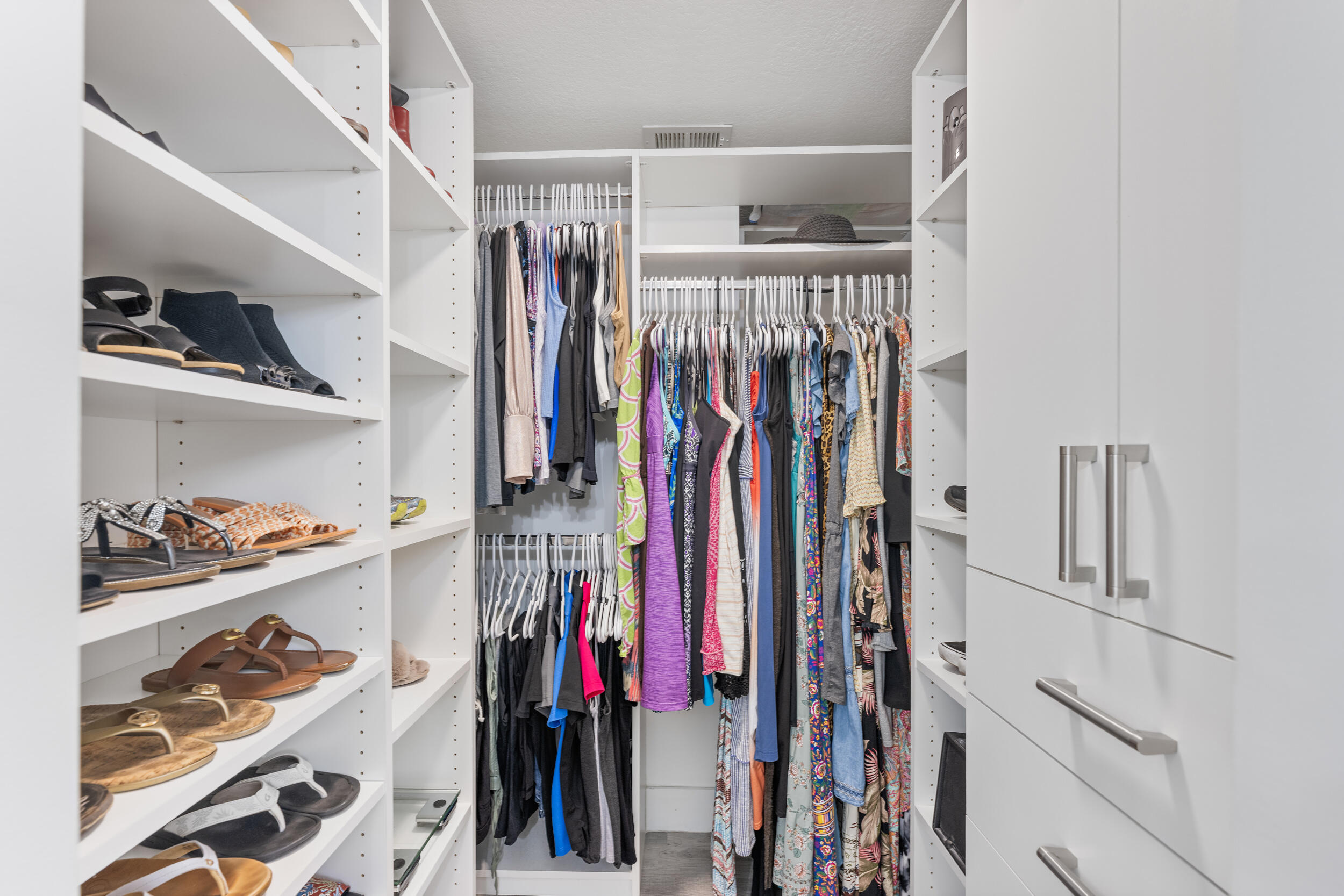 17867 Thelma Avenue, Unit A Jupiter, FL 33458 - Photo 14 of 35 a view of walk in closet with clothes and shoes