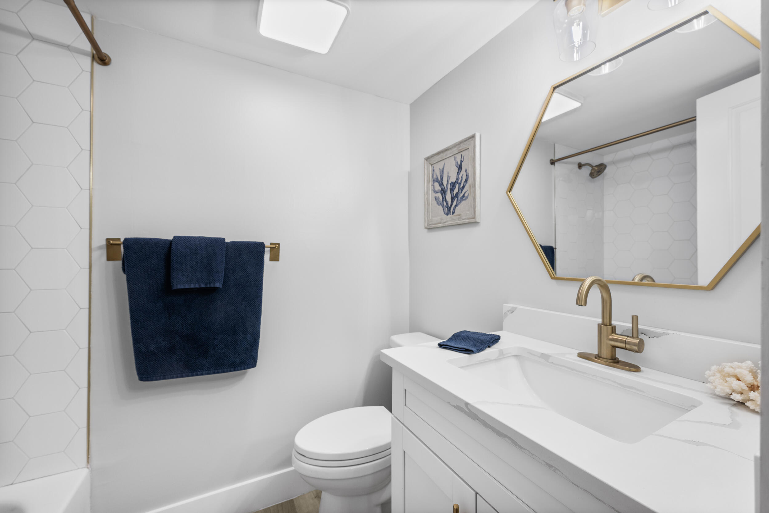 17867 Thelma Avenue, Unit A Jupiter, FL 33458 - Photo 17 of 35 a bathroom with a toilet sink and mirror