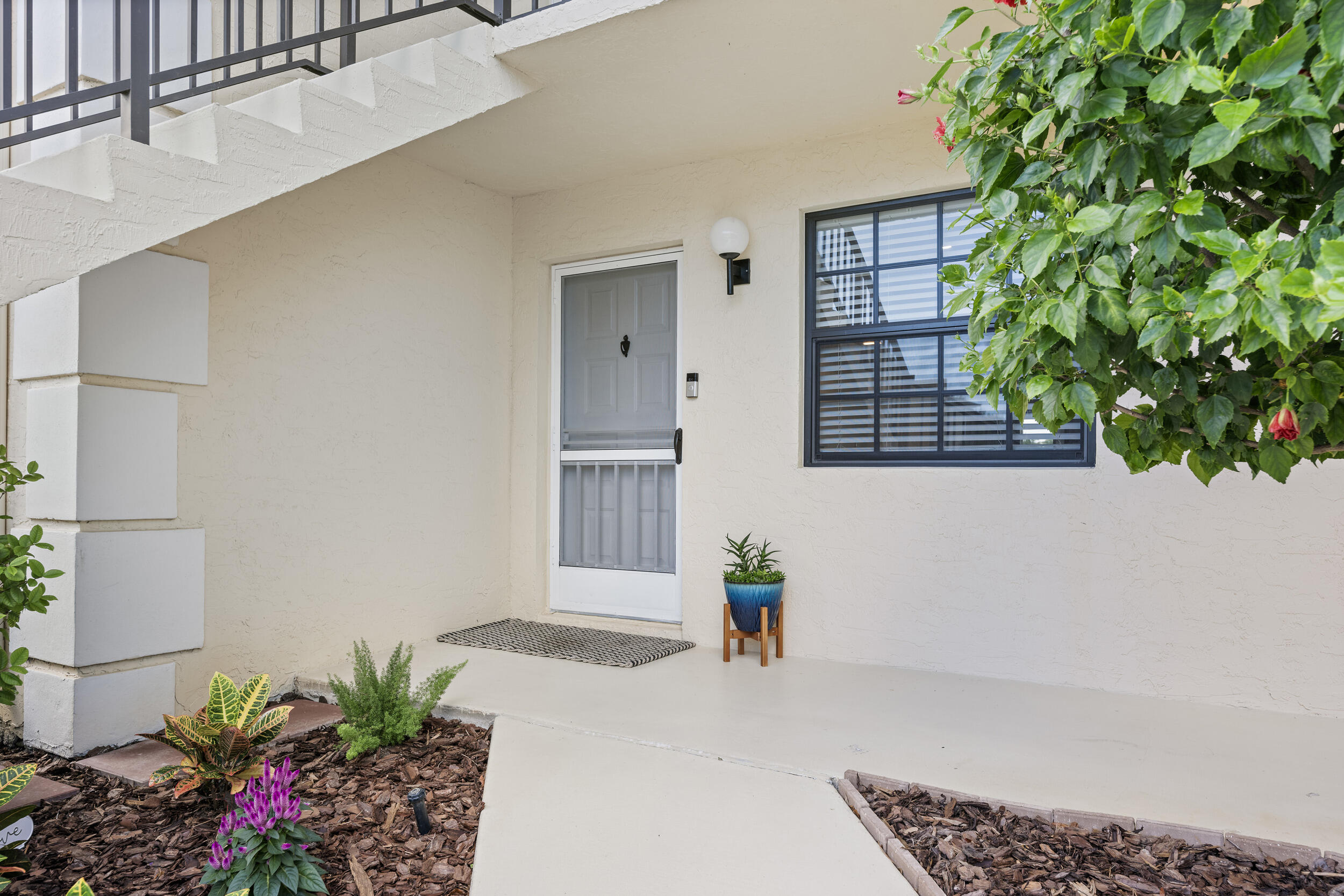 17867 Thelma Avenue, Unit A Jupiter, FL 33458 - Photo 26 of 35 a view of entryway with flower pots