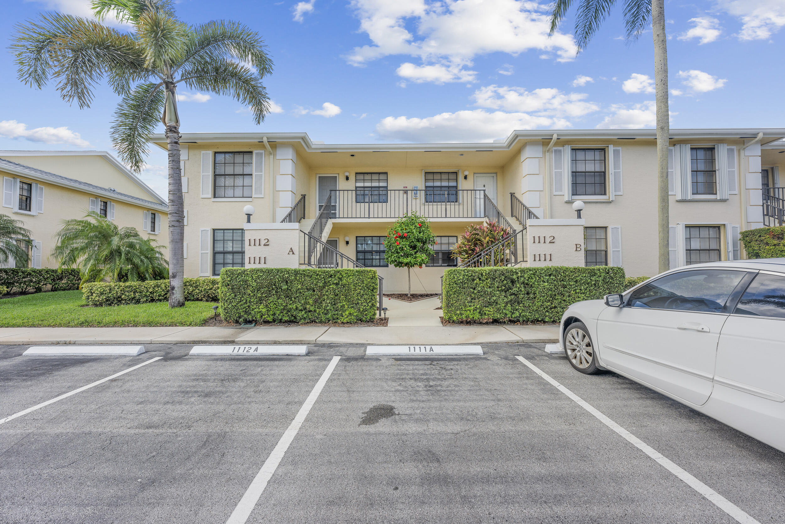17867 Thelma Avenue, Unit A Jupiter, FL 33458 - Photo 27 of 35 a view of a white house with a yard and plants