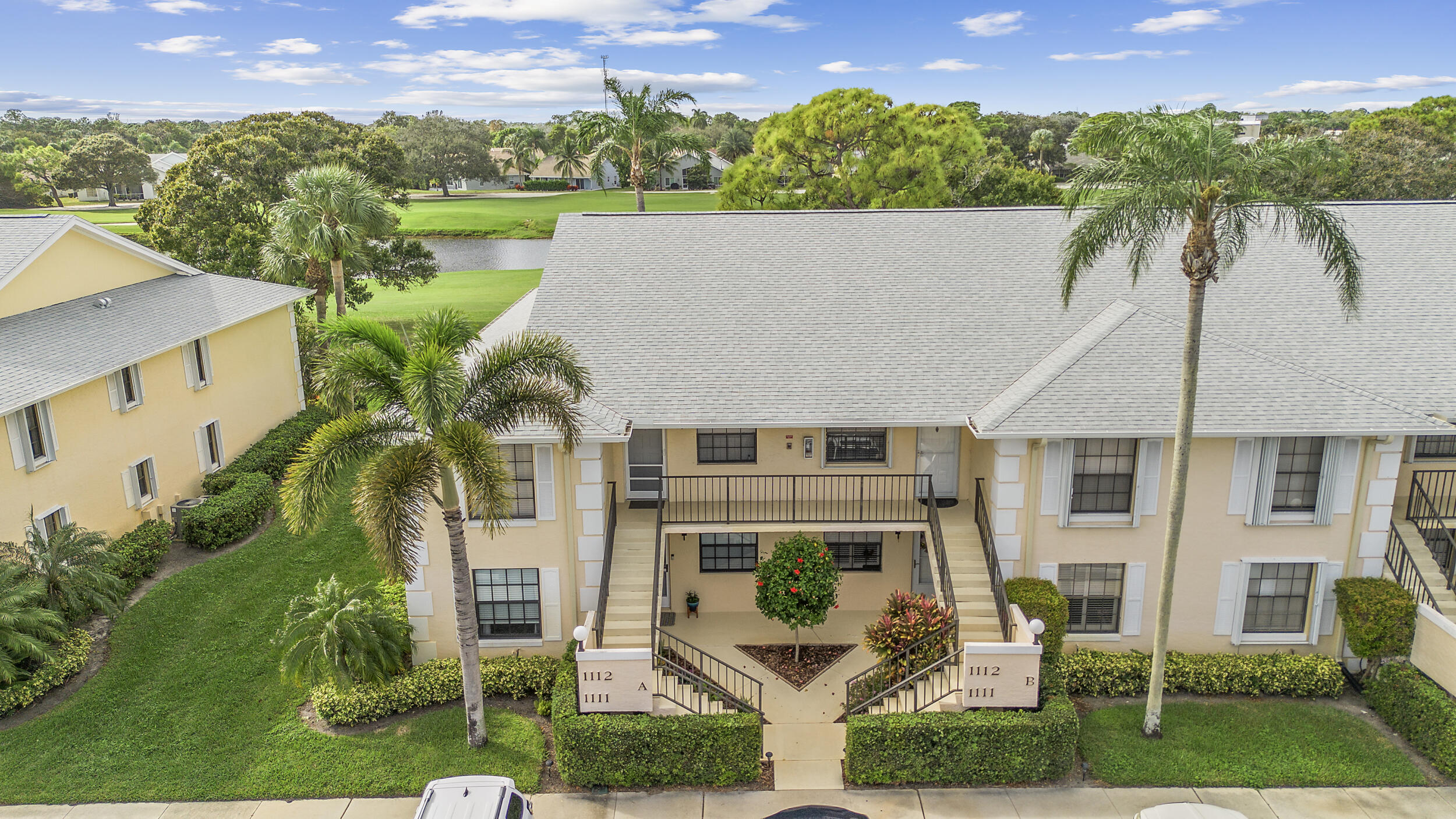 17867 Thelma Avenue, Unit A Jupiter, FL 33458 - Photo 28 of 35 a aerial view of a house with a yard and a large tree