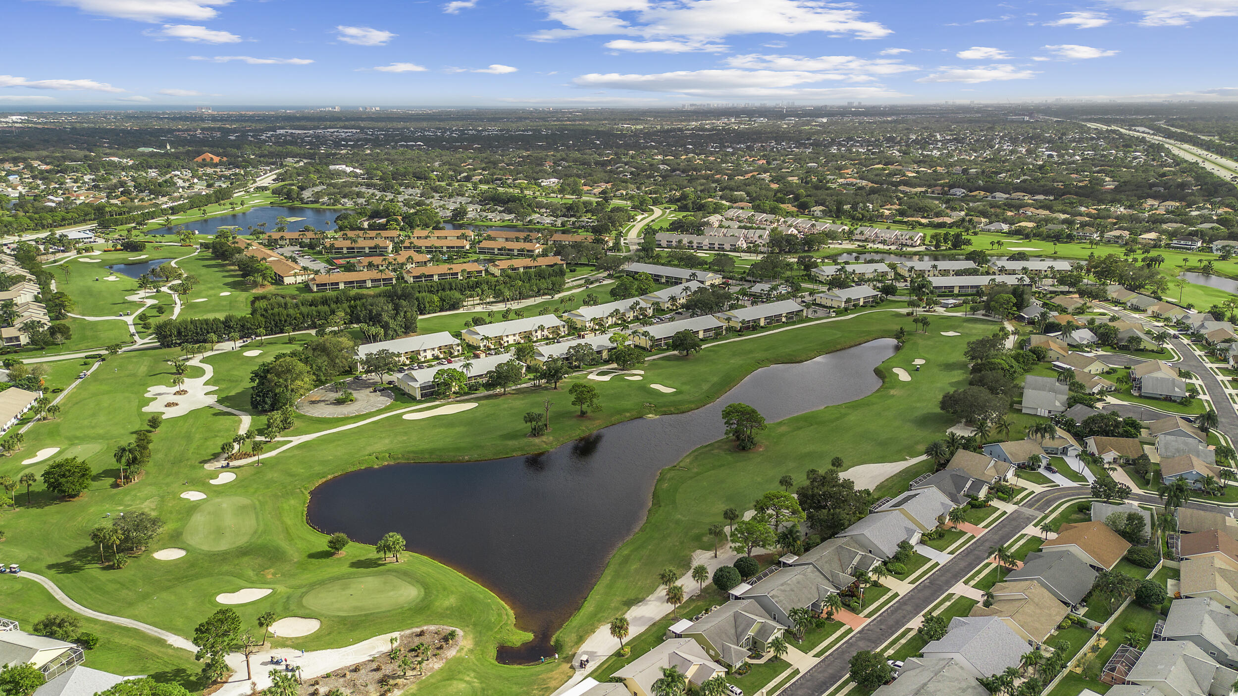 17867 Thelma Avenue, Unit A Jupiter, FL 33458 - Photo 32 of 35 an aerial view of residential houses with outdoor space