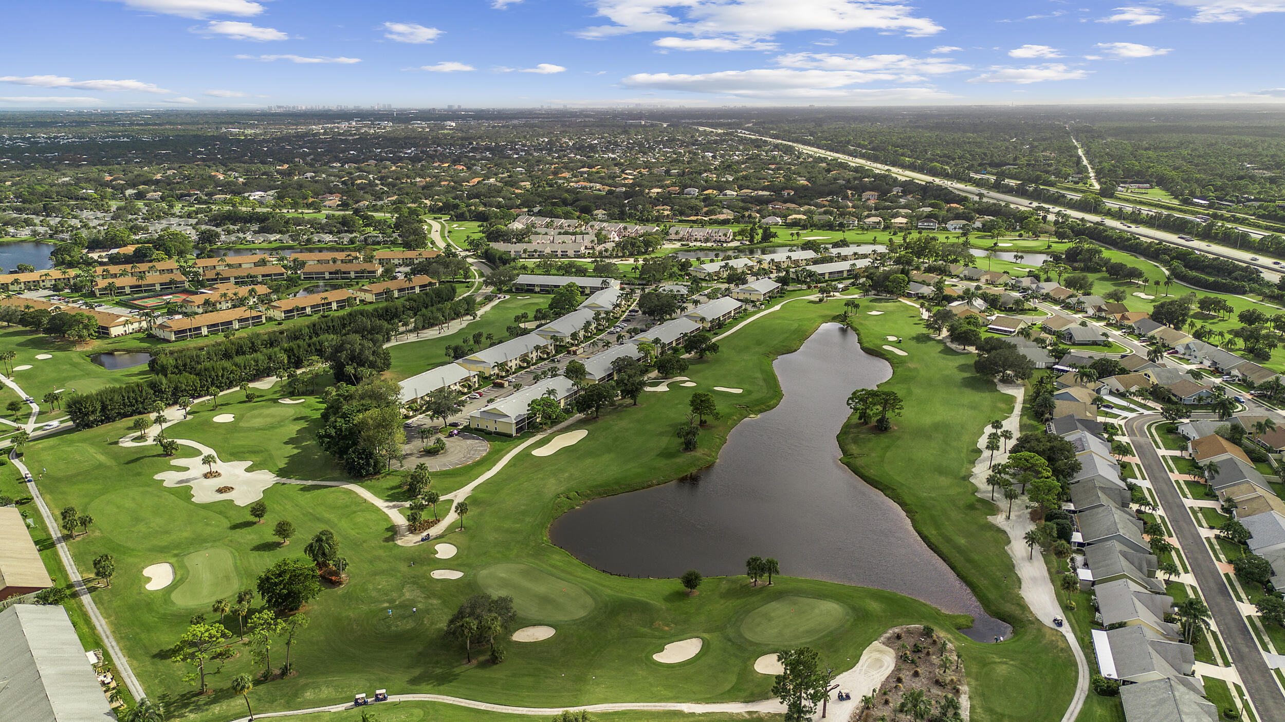 17867 Thelma Avenue, Unit A Jupiter, FL 33458 - Photo 33 of 35 an aerial view of residential houses with outdoor space and trees
