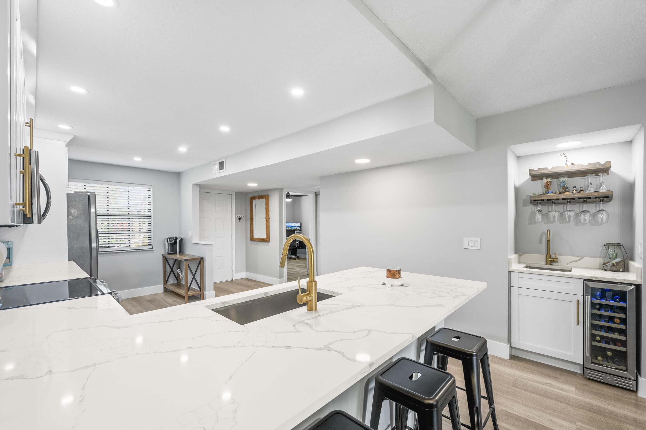 17867 Thelma Avenue, Unit A Jupiter, FL 33458 - Photo 4 of 35 a kitchen with a dining table chairs and refrigerator