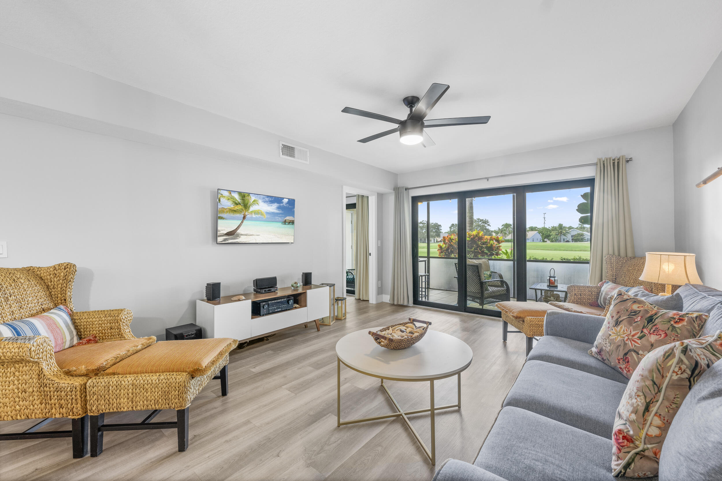 17867 Thelma Avenue, Unit A Jupiter, FL 33458 - Photo 7 of 35 a living room with furniture and a large window