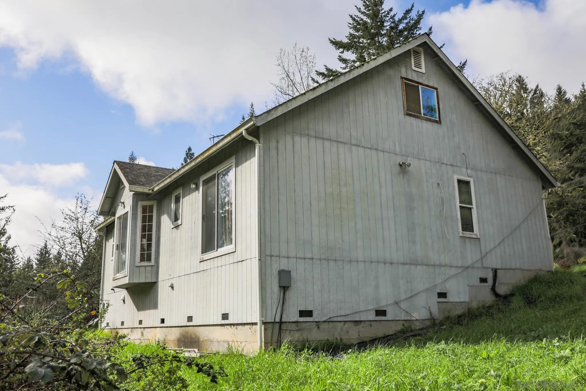 9897 Dyerville Loop Road Myers Flat, CA 95554 - Photo 9 of 24 a house with trees in the background