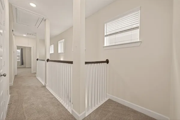 a view of a hallway with windows