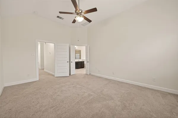 an empty room with closet and windows