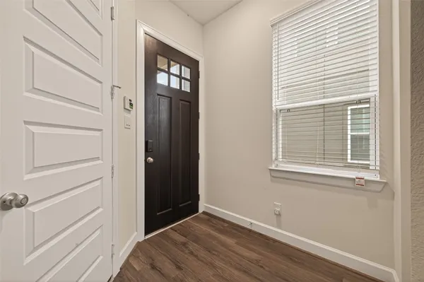 a view of an entryway with wooden floor