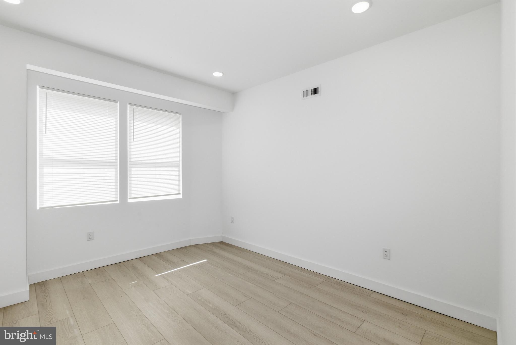 1005 West Orleans Street Philadelphia, PA 19133 - Photo 12 of 25 an empty room with wooden floor and windows