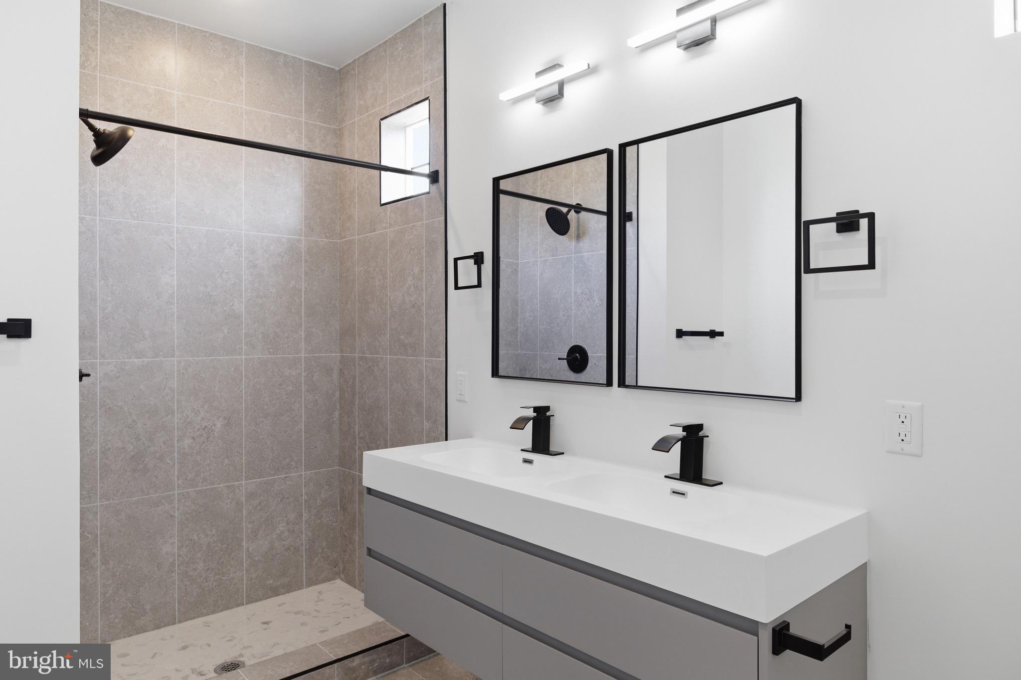 1005 West Orleans Street Philadelphia, PA 19133 - Photo 15 of 25 a bathroom with a sink and mirror