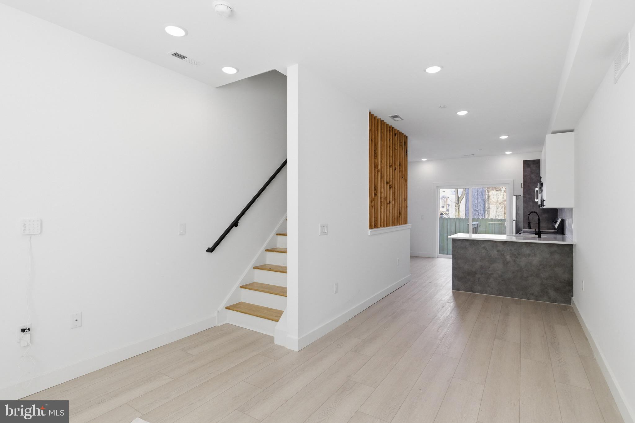 1005 West Orleans Street Philadelphia, PA 19133 - Photo 2 of 25 a view of a living room and kitchen with furniture