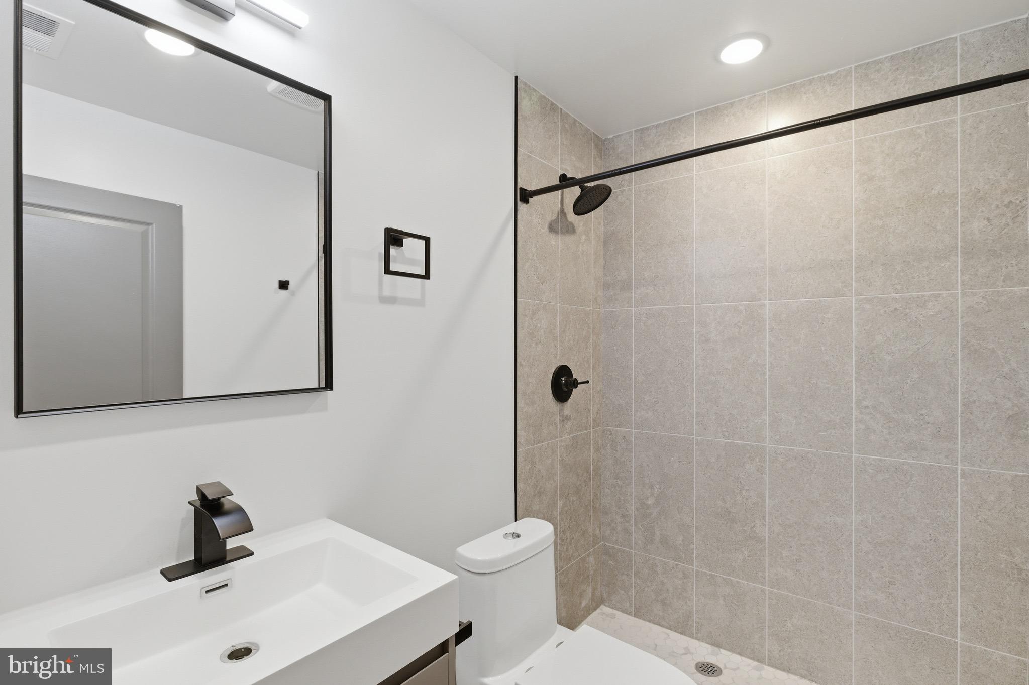 1005 West Orleans Street Philadelphia, PA 19133 - Photo 21 of 25 a bathroom with a sink a toilet and shower