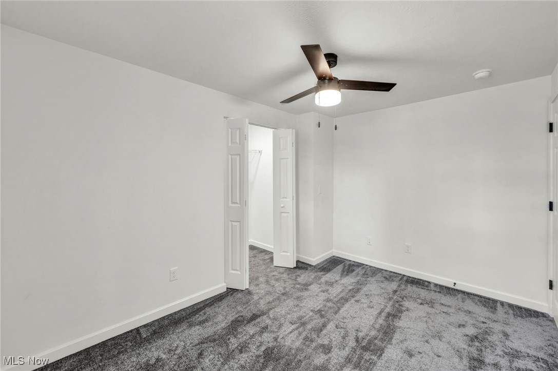 43575 Cream Ridge Road Lisbon, OH 44432 - Photo 26 of 50 Unfurnished bedroom featuring dark carpet and a ceiling fan