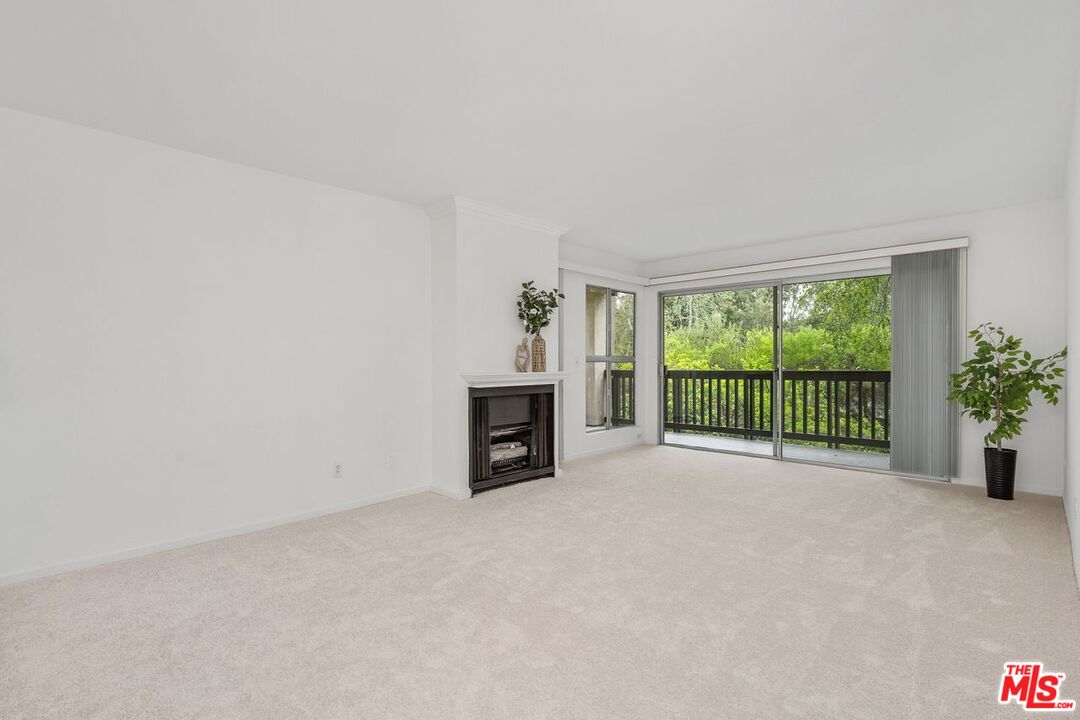1211 Raintree Circle Culver City, CA 90230 - Photo 12 of 44 a view of an empty room with a fireplace and a window