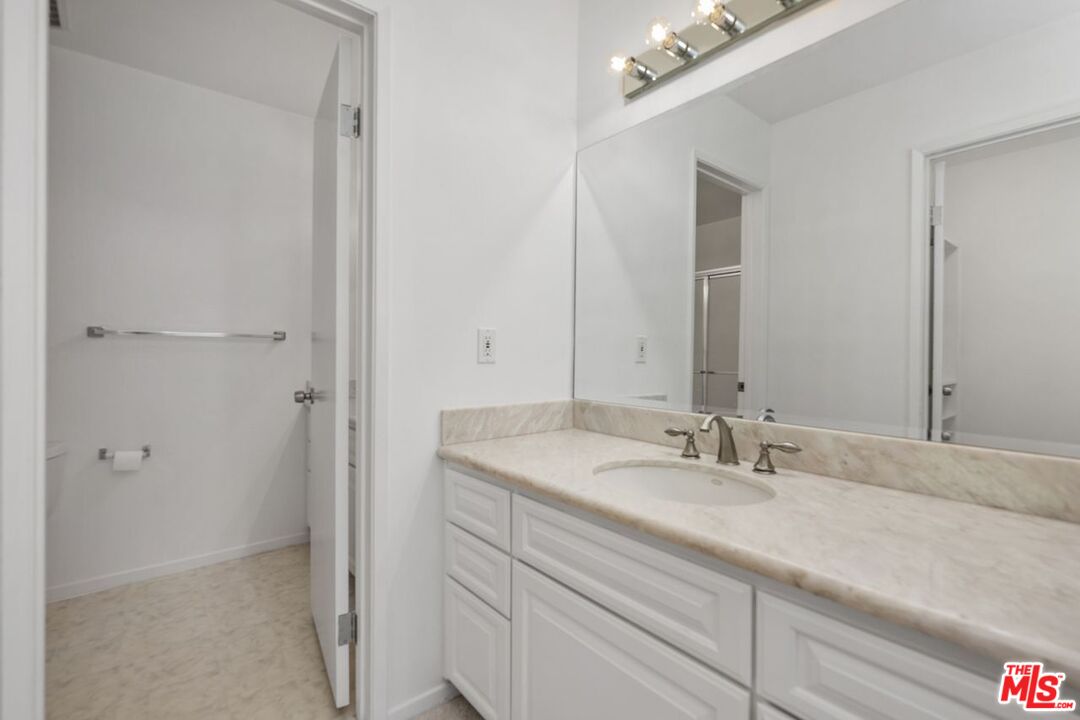 1211 Raintree Circle Culver City, CA 90230 - Photo 20 of 44 a bathroom with a sink and a mirror