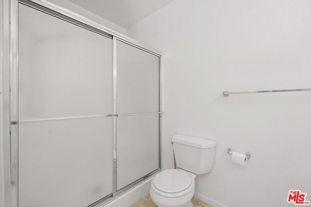 1211 Raintree Circle Culver City, CA 90230 - Photo 22 of 44 a white toilet sitting next to a shower
