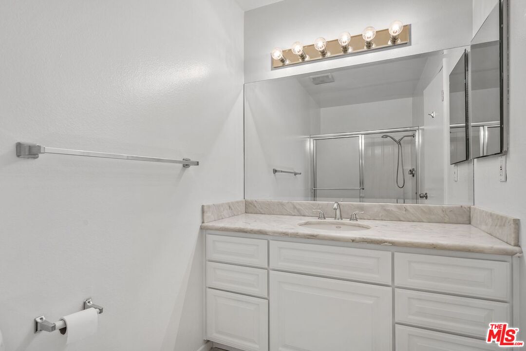 1211 Raintree Circle Culver City, CA 90230 - Photo 23 of 44 a bathroom with a granite countertop sink and a mirror