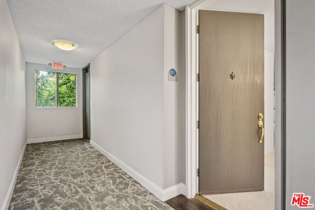 1211 Raintree Circle Culver City, CA 90230 - Photo 4 of 44 a view of hallway with window and a bathroom