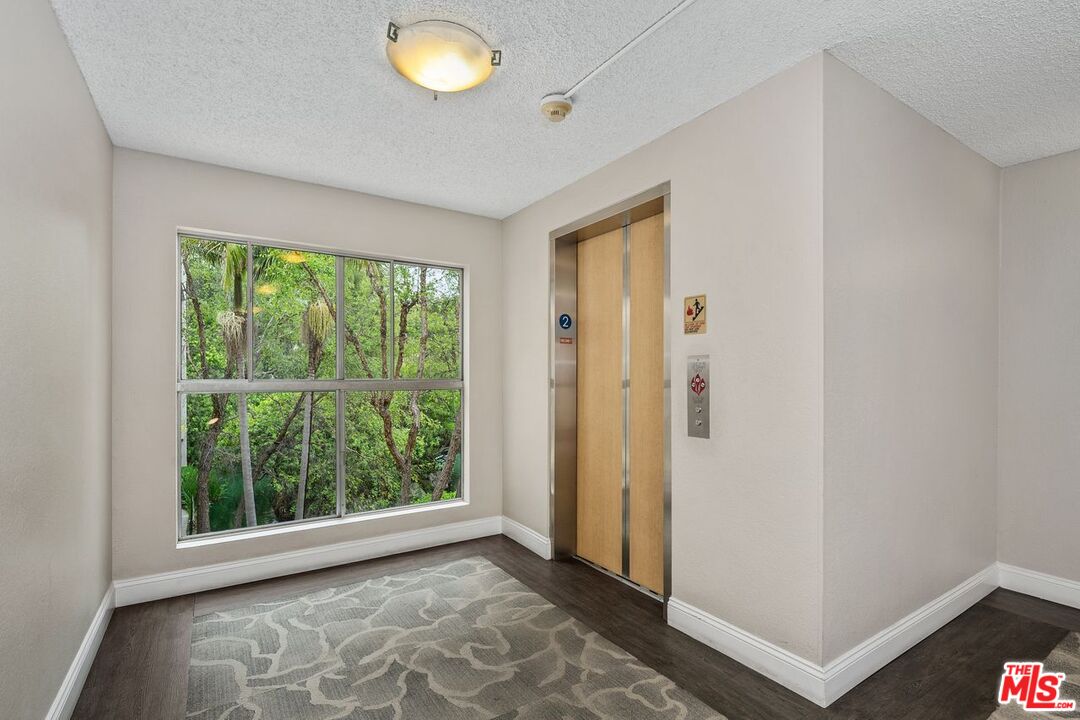 1211 Raintree Circle Culver City, CA 90230 - Photo 44 of 44 a view of an empty room with wooden floor and a window