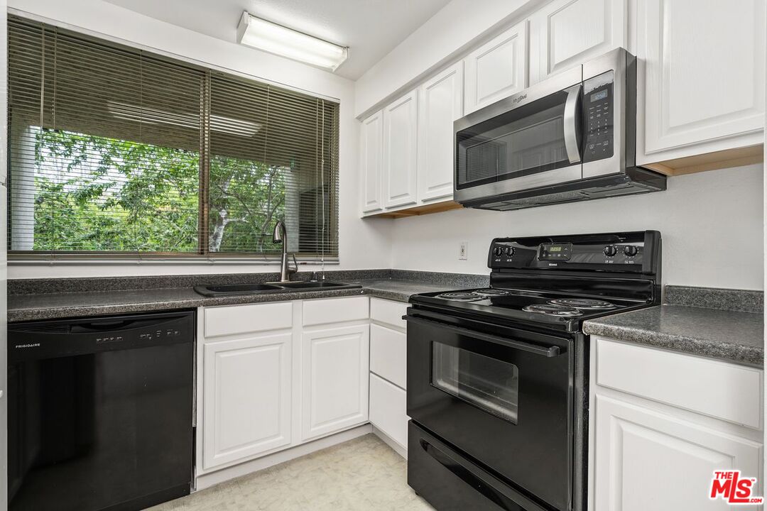 1211 Raintree Circle Culver City, CA 90230 - Photo 5 of 44 a kitchen with a stove microwave and sink