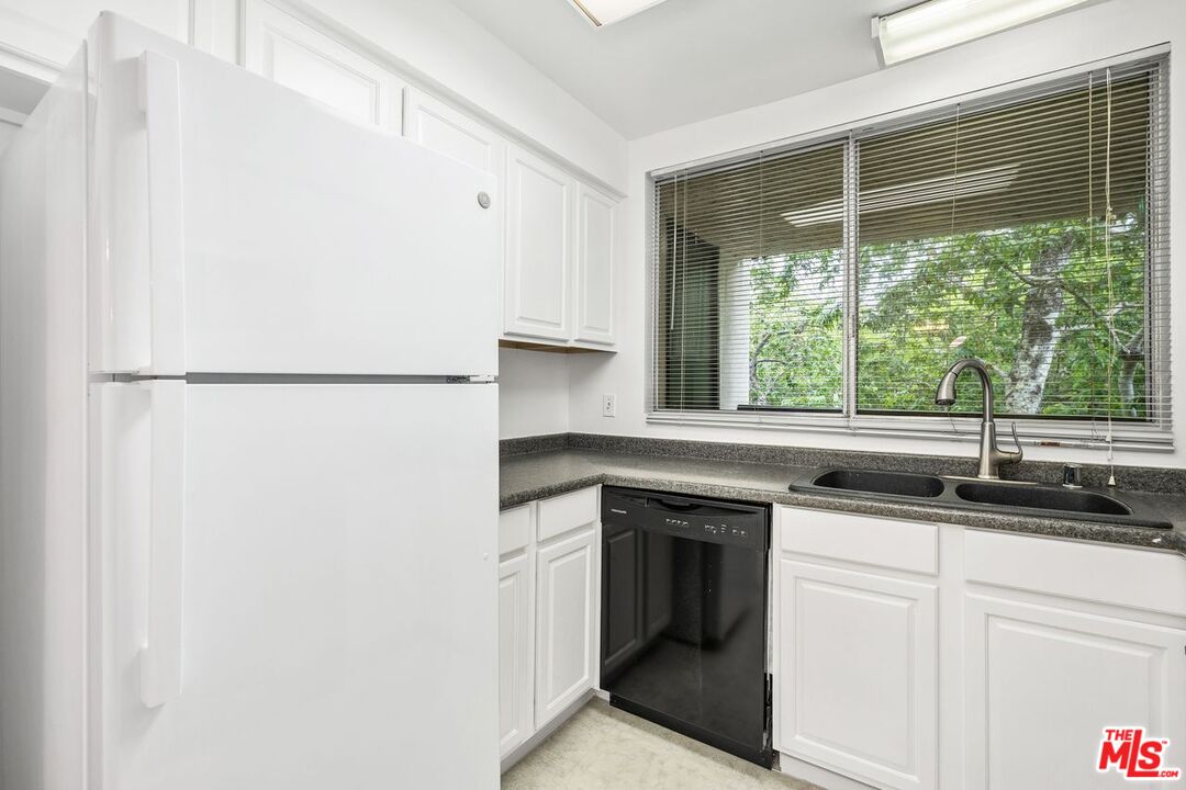 1211 Raintree Circle Culver City, CA 90230 - Photo 7 of 44 a kitchen with a sink and a refrigerator