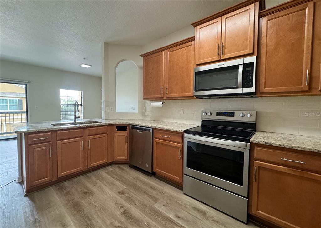 View of Kitchen, Great Room, and Private Balcony