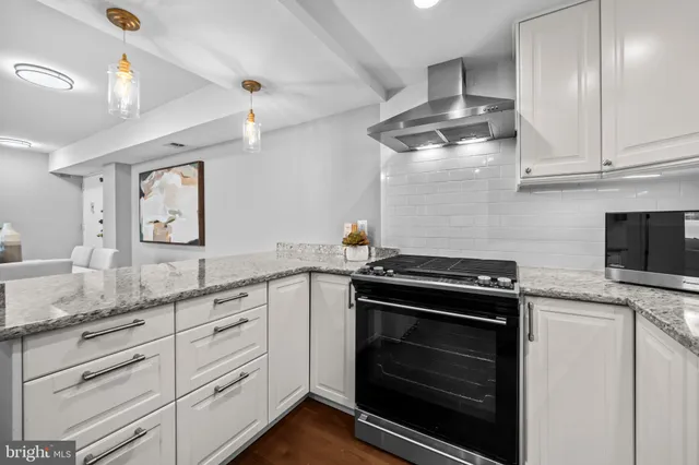 a kitchen with granite countertop a stove and a sink