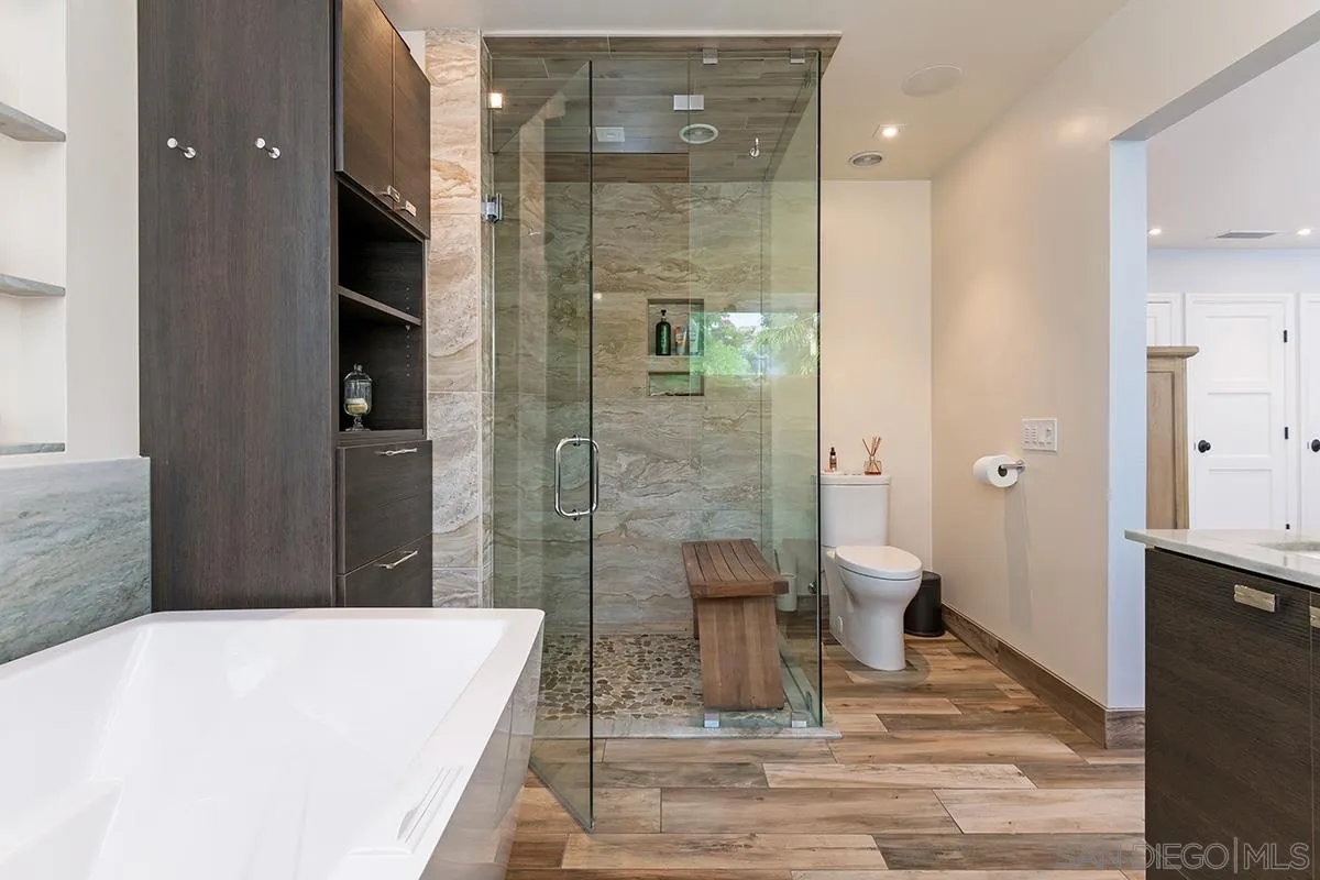 14316 High Valley Road Poway, CA 92064 - Photo 11 of 32 a bathroom with a granite countertop sink a toilet and shower