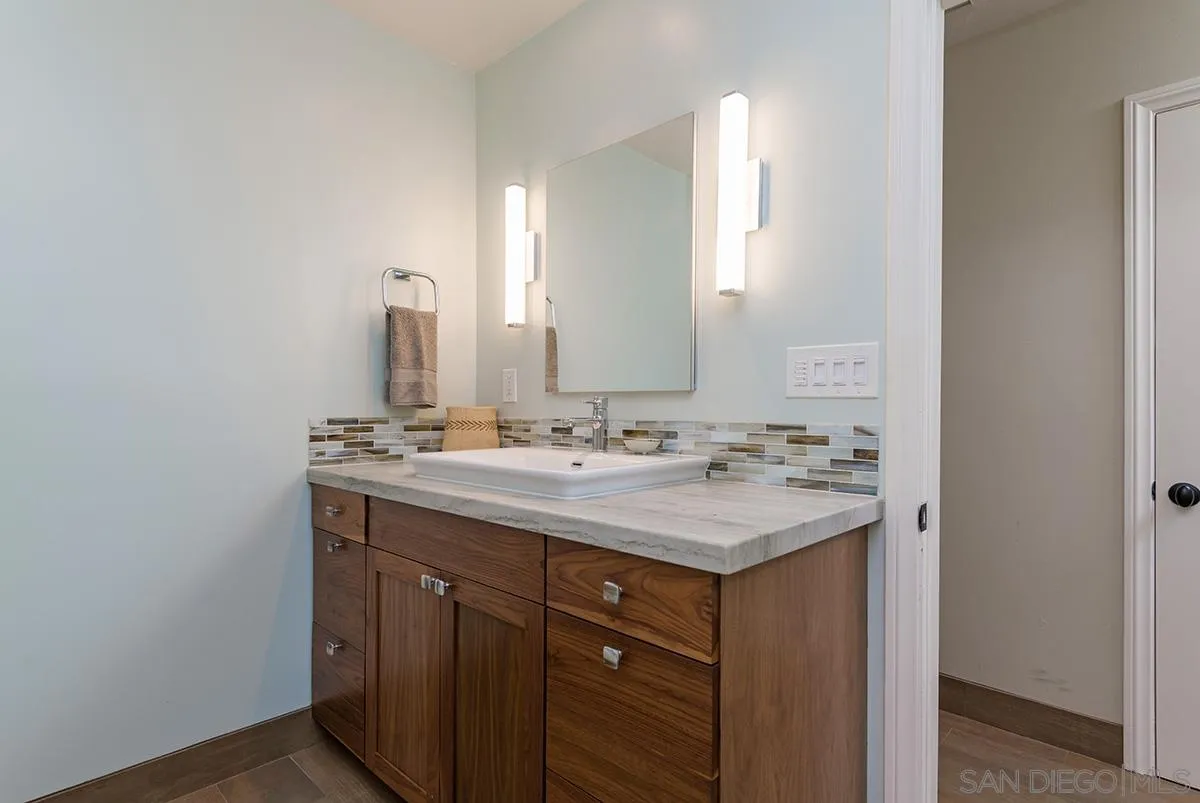 14316 High Valley Road Poway, CA 92064 - Photo 14 of 32 a bathroom with a sink and a mirror
