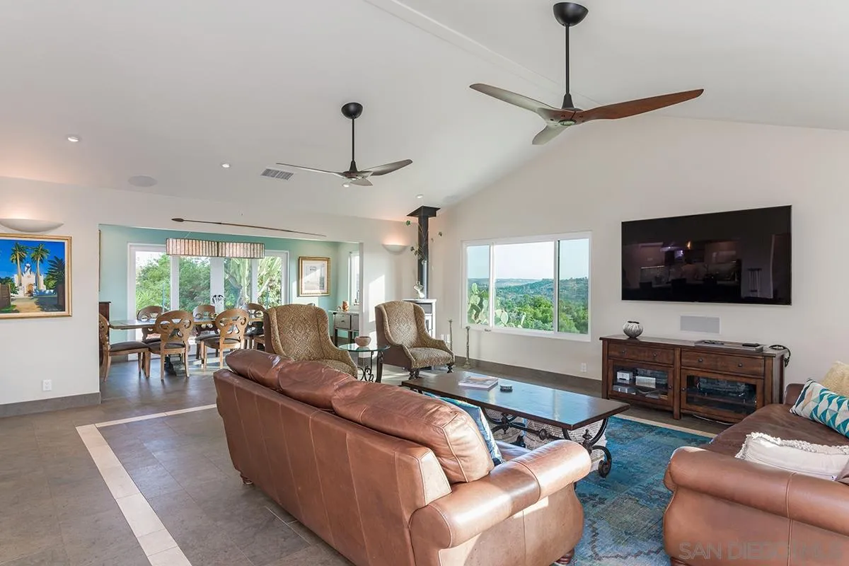 14316 High Valley Road Poway, CA 92064 - Photo 4 of 32 a living room with furniture flat screen tv and a large window