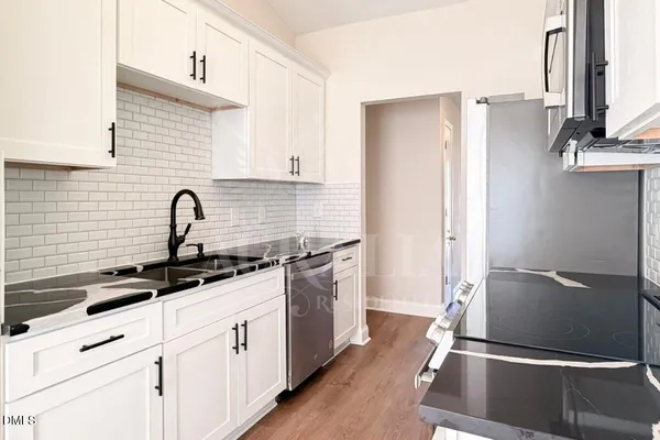 a kitchen with a refrigerator and a sink