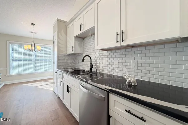 a kitchen with a sink cabinets and window