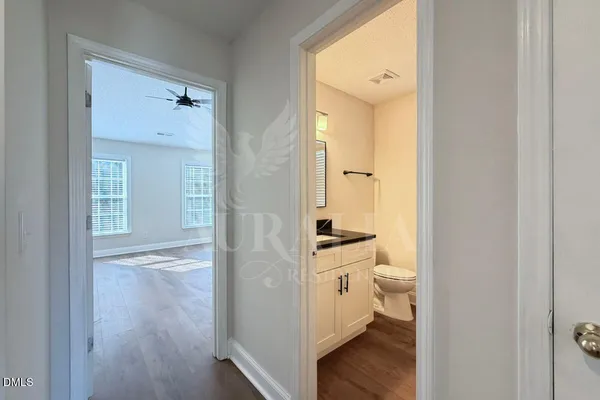 a bathroom with a granite countertop sink mirror and toilet
