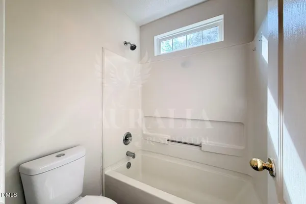 a bathroom with a toilet and a bathtub