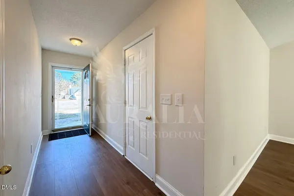 a view of a hallway with wooden floor