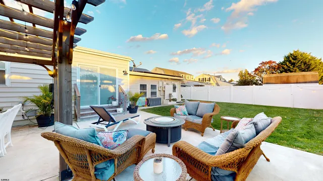 a living room with furniture and kitchen view