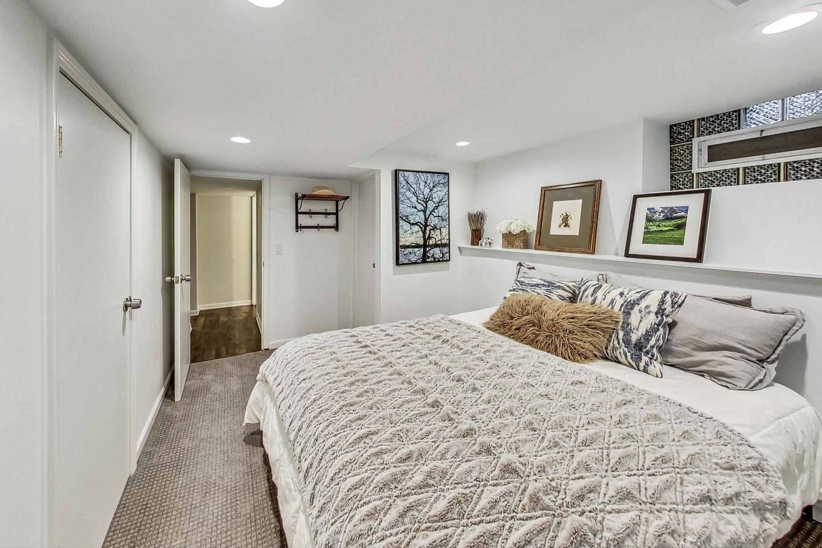 352 Addison Road Riverside, IL 60546 - Photo 50 of 63 a bedroom with a large bed and a walk in closet