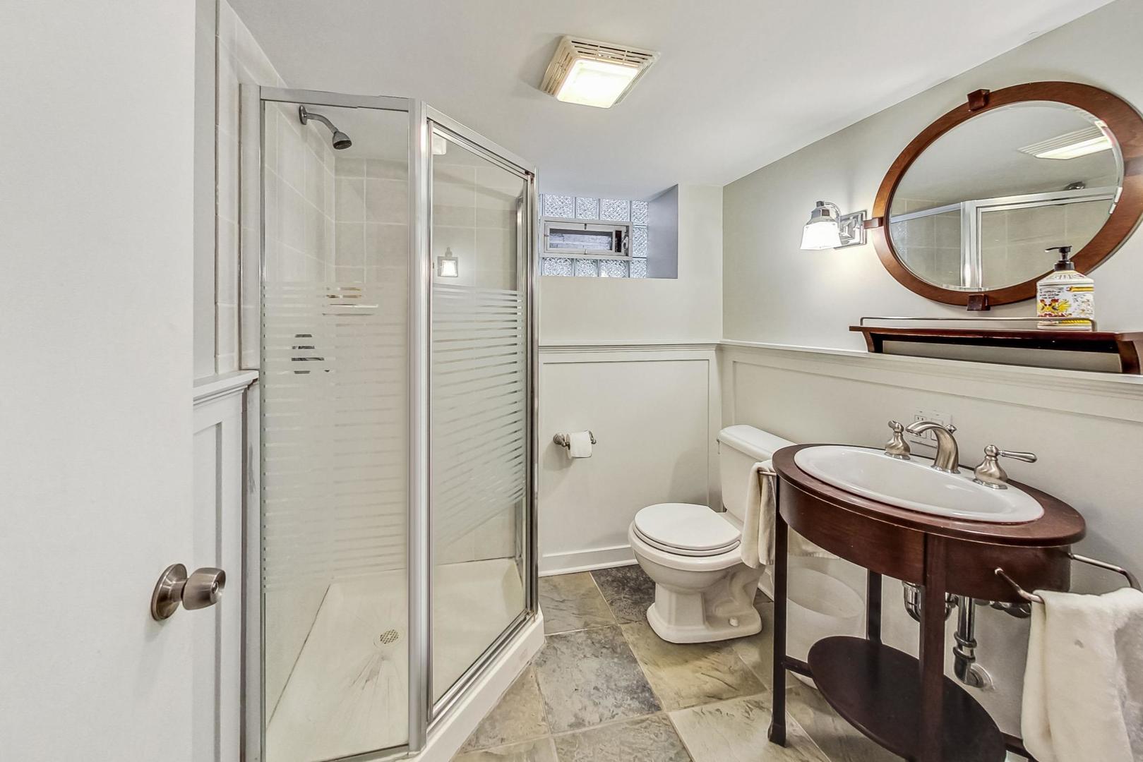 352 Addison Road Riverside, IL 60546 - Photo 51 of 63 a bathroom with a toilet a sink and a mirror