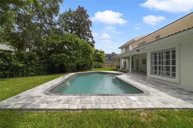 a view of pool with yard