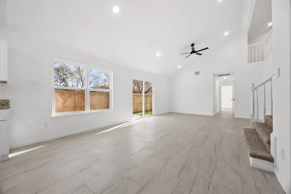 a view of a kitchen with furniture and a ceiling fan