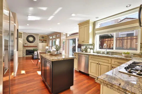 a kitchen with stainless steel appliances granite countertop a stove and cabinets