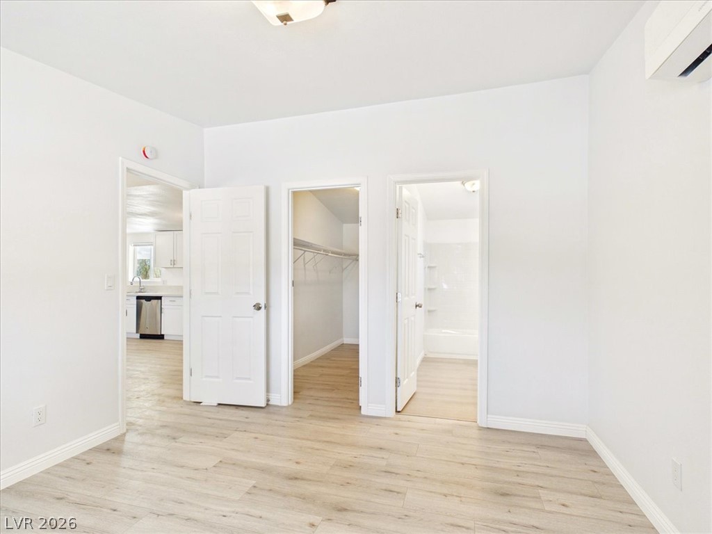4081 Retread Road Pahrump, NV 89048 - Photo 29 of 98 A well-lit, adaptable room features light wood-style flooring and direct access to a kitchen, closet, and bathroom.