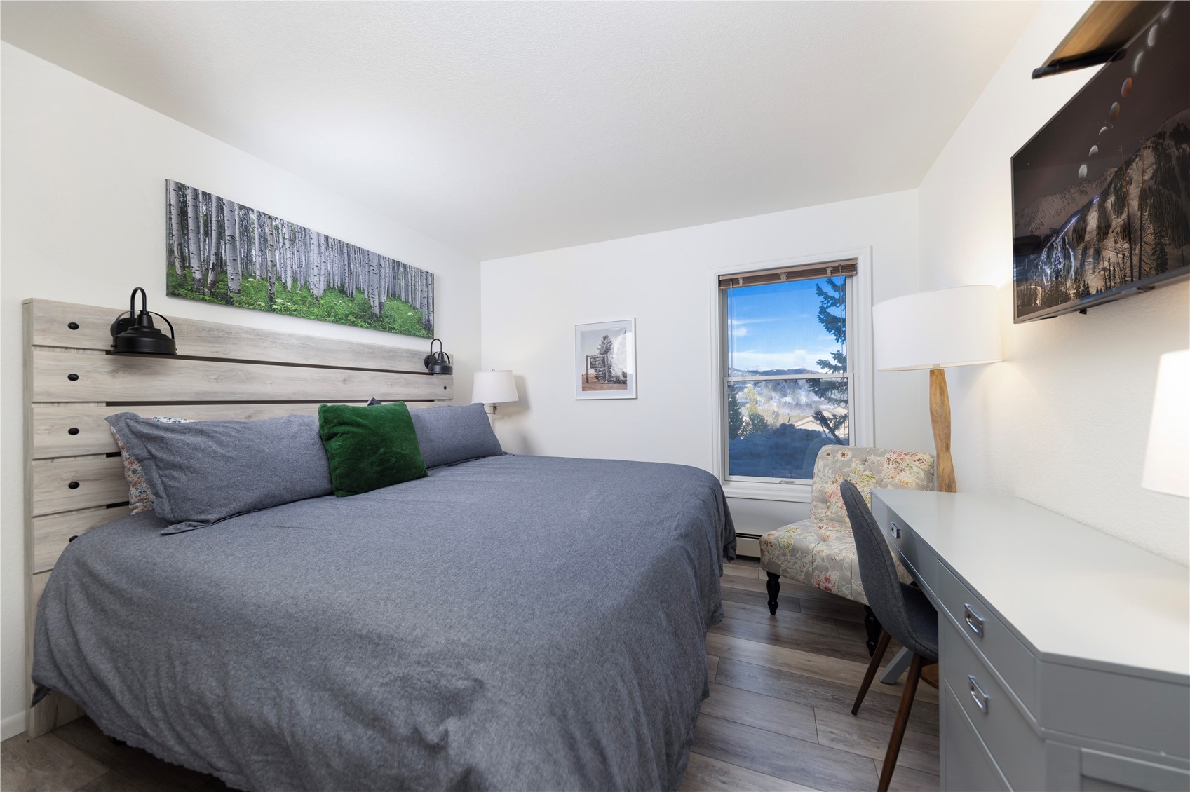 89410 Ryan Gulch Road, Unit 104 Silverthorne, CO 80498 - Photo 9 of 31 a bed room with a bed and a chair