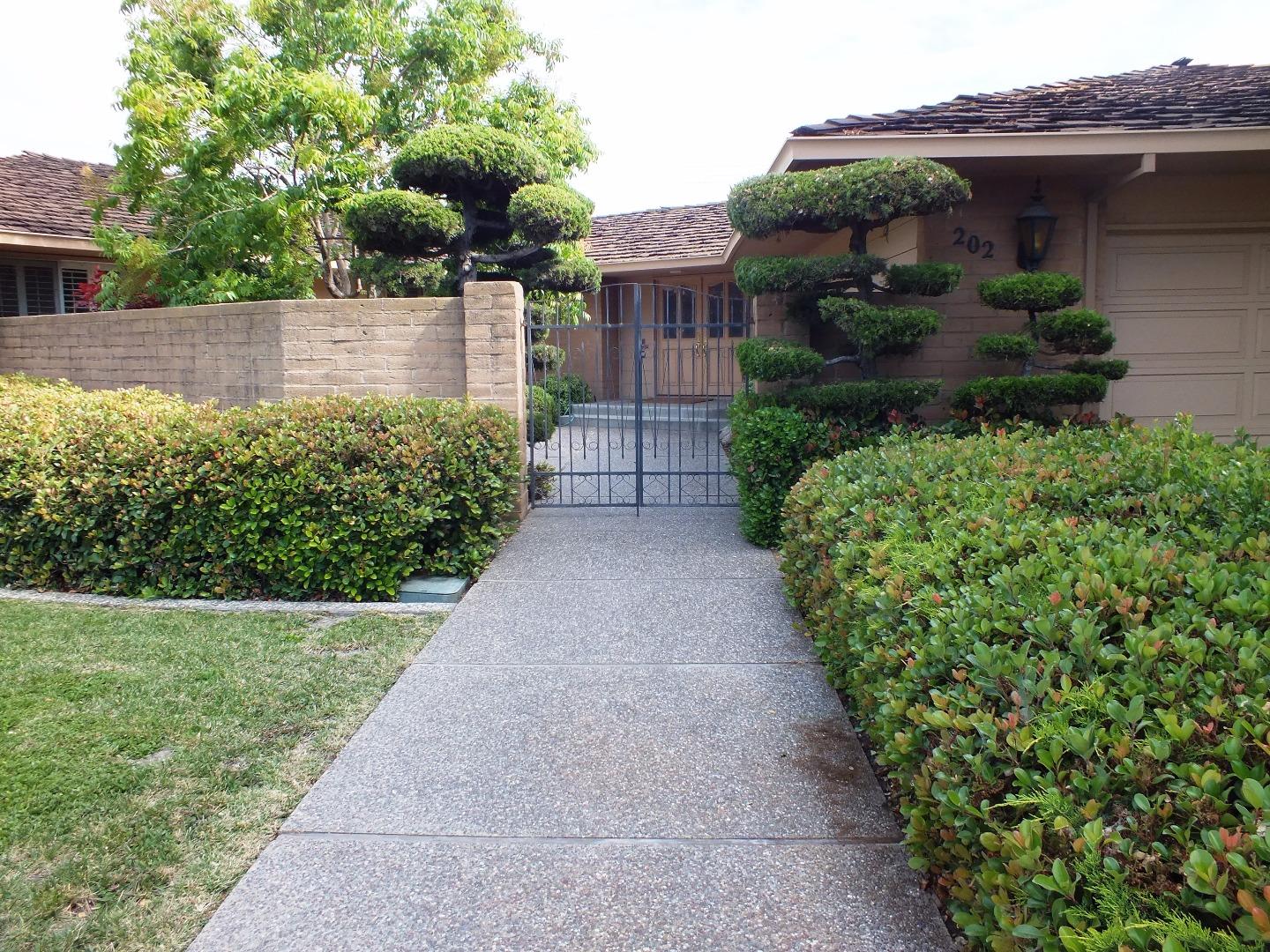 202 Rio Verde Drive Salinas, CA 93901 - Photo 4 of 35 a front view of a house with a yard and potted plants